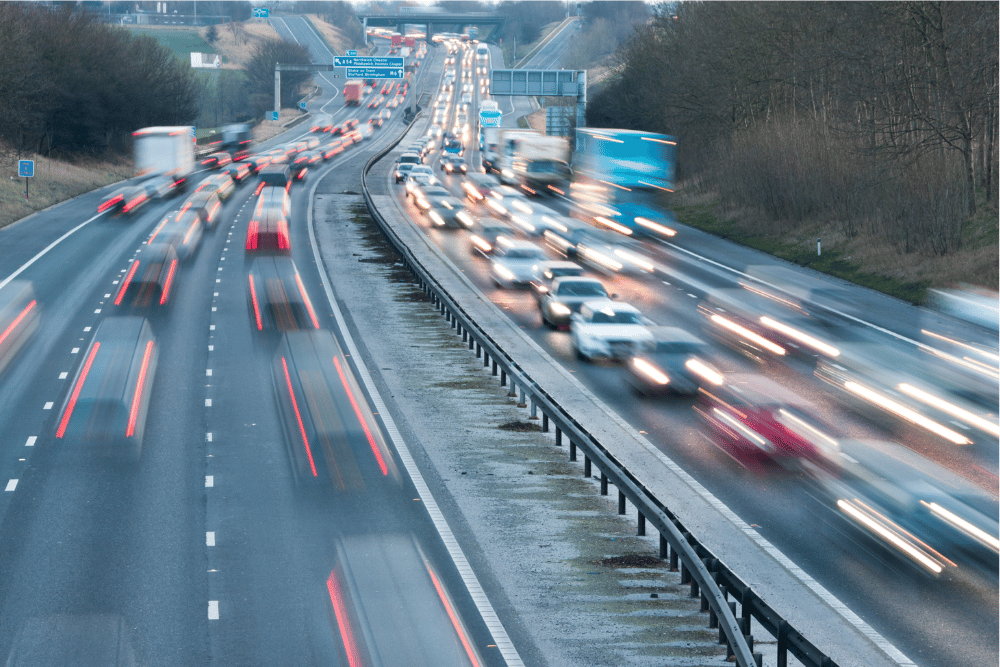 Fast moving vehicles on both sides of a stretch of motorway