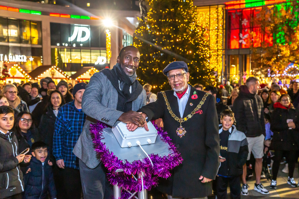 Jimmy Floyd Hasselbaink with the Mayor of Woking standing the on switch.