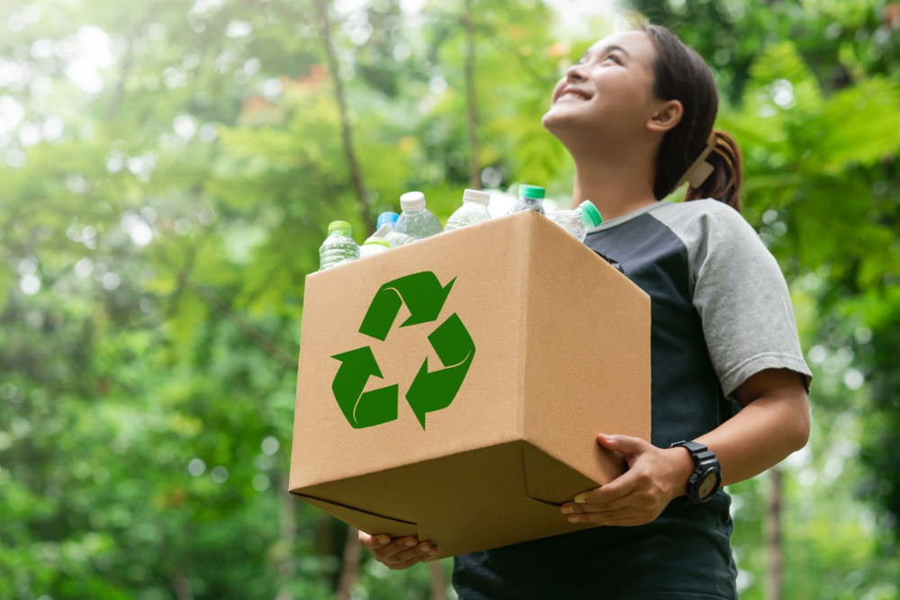 Girl holding recycling box